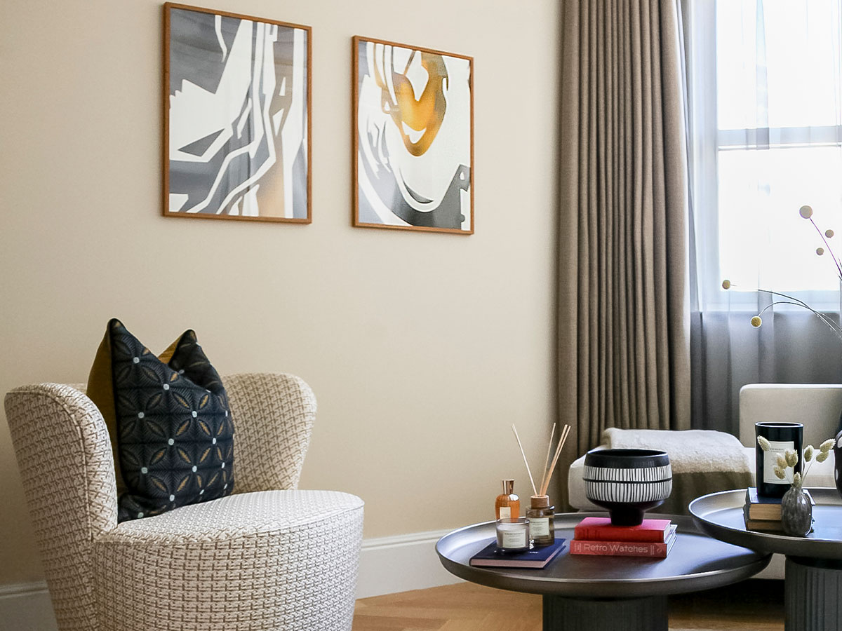 Stylish living room with armchair, coffee table, and artwork of 9 Milbank