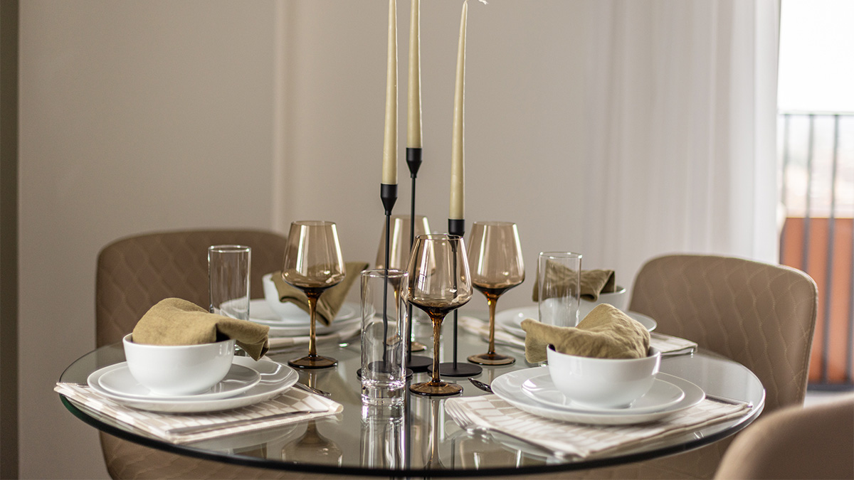Glass table with plates and glasses at Pintail Heights