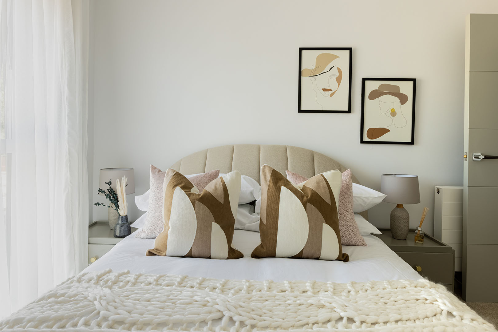 Bedroom with face line art above bed - stylish decor