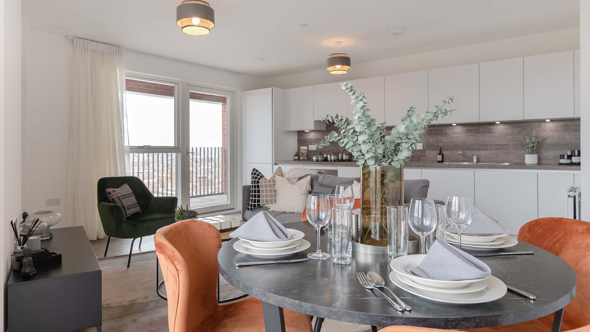Dining table, orange chairs, and city view