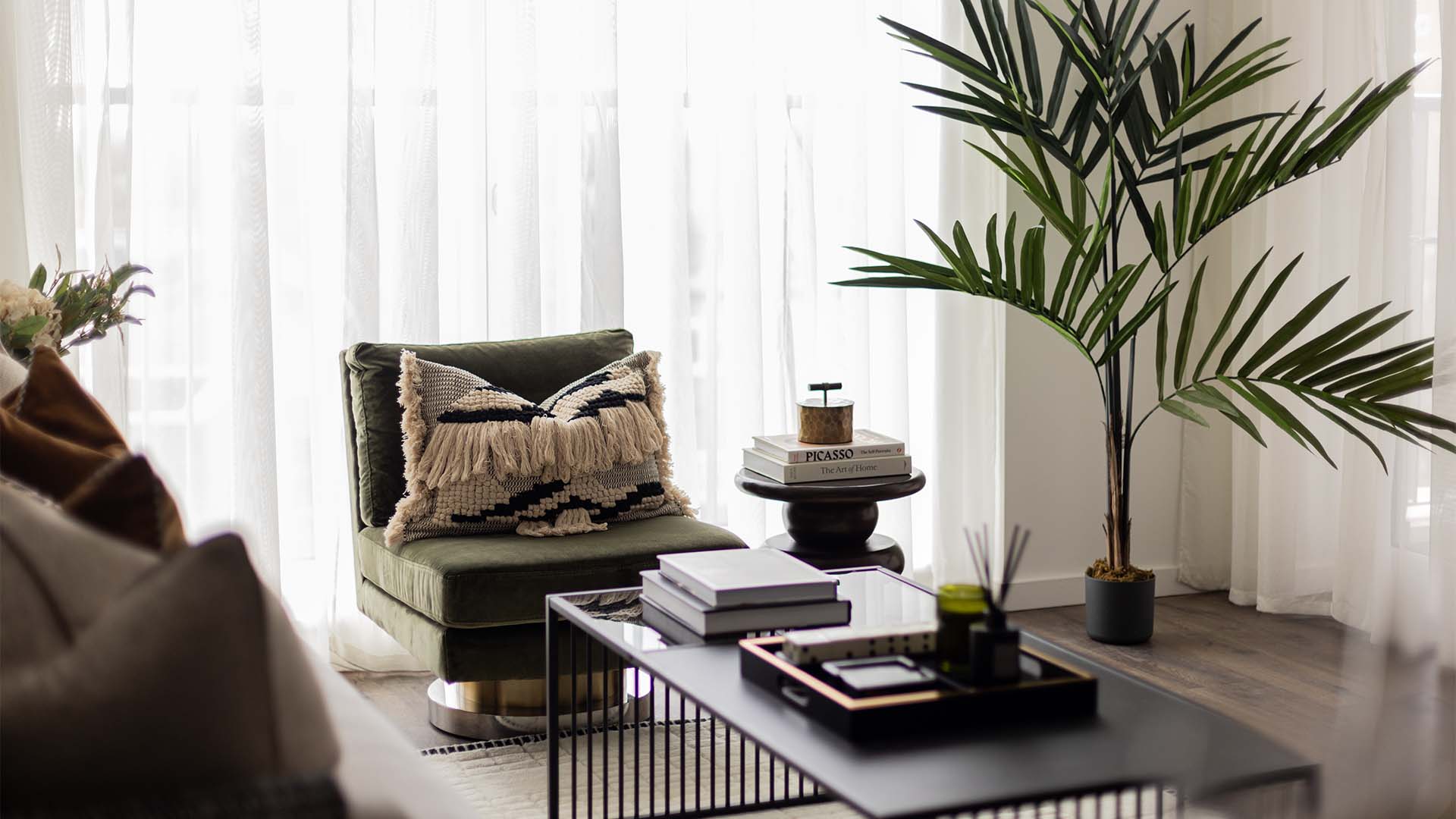 Modern living room with plant and artwork at W1 Place-16