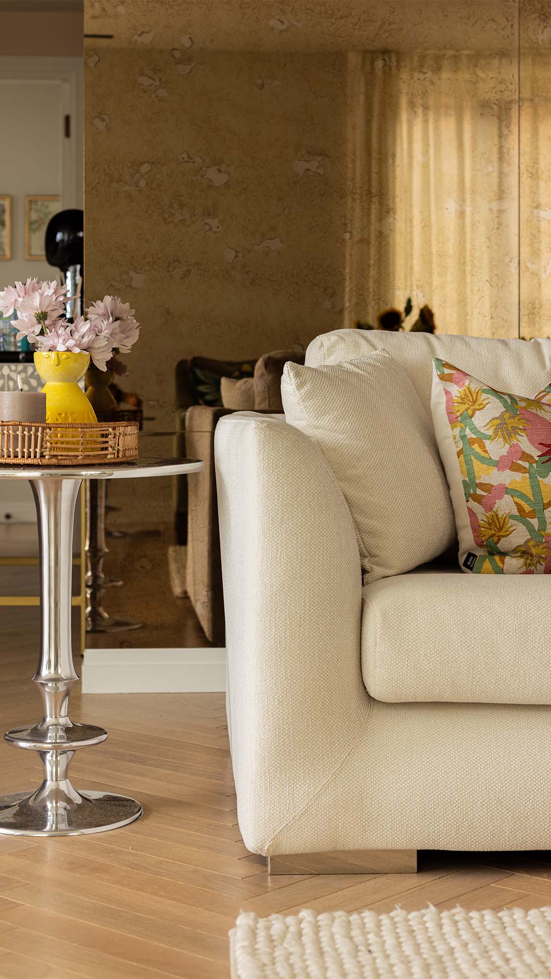 White sofa, side table with flowers, and mirror. at Saxon House-08