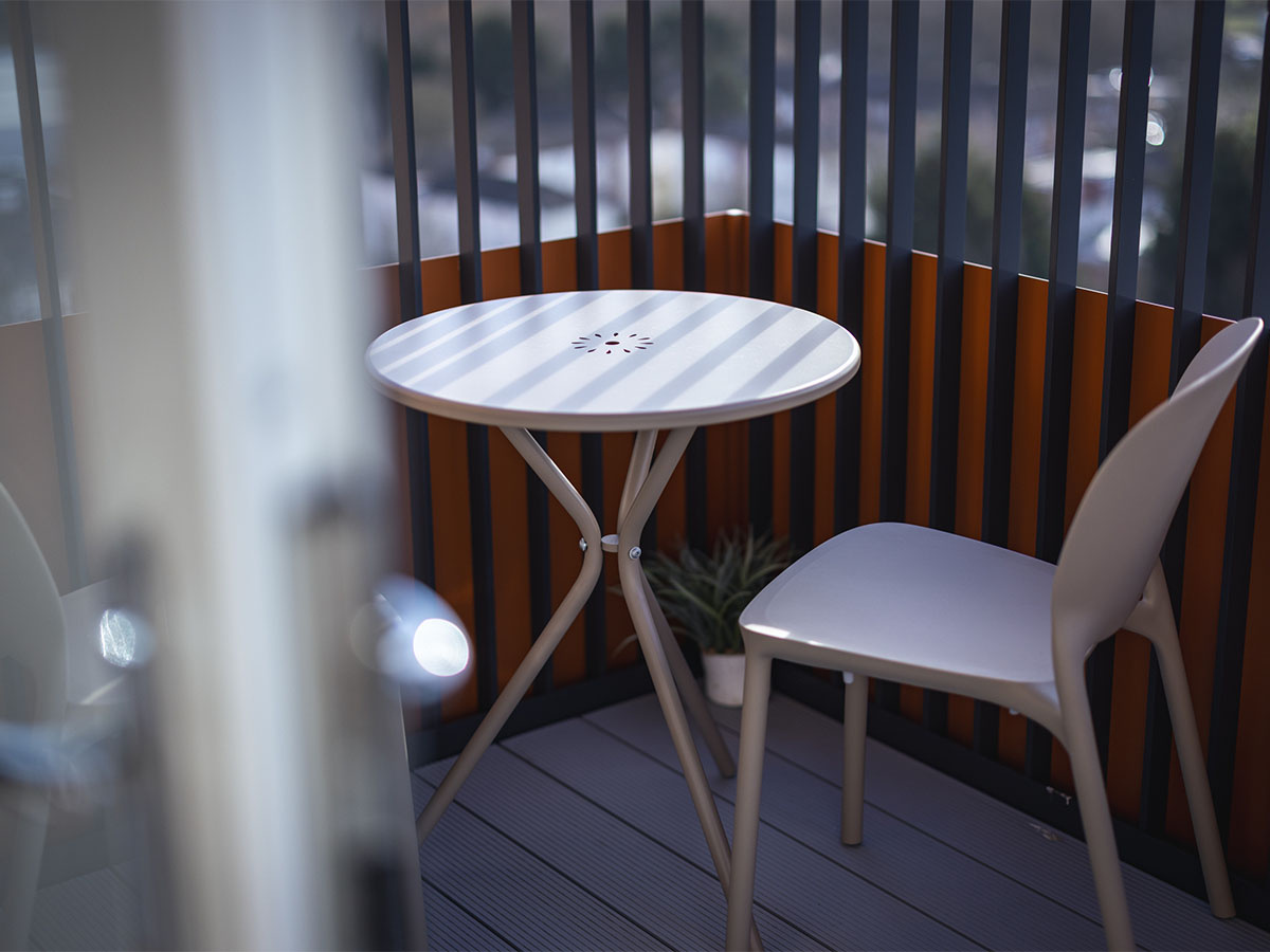 white outdoor table and chair on balcony at square roots