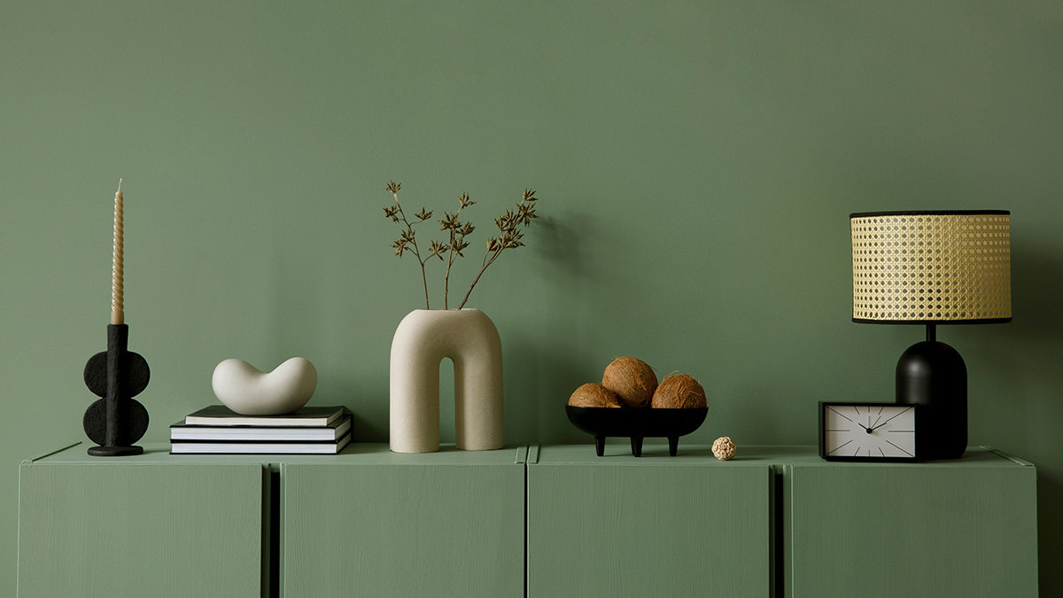 Green ceramic vase, books, lamp