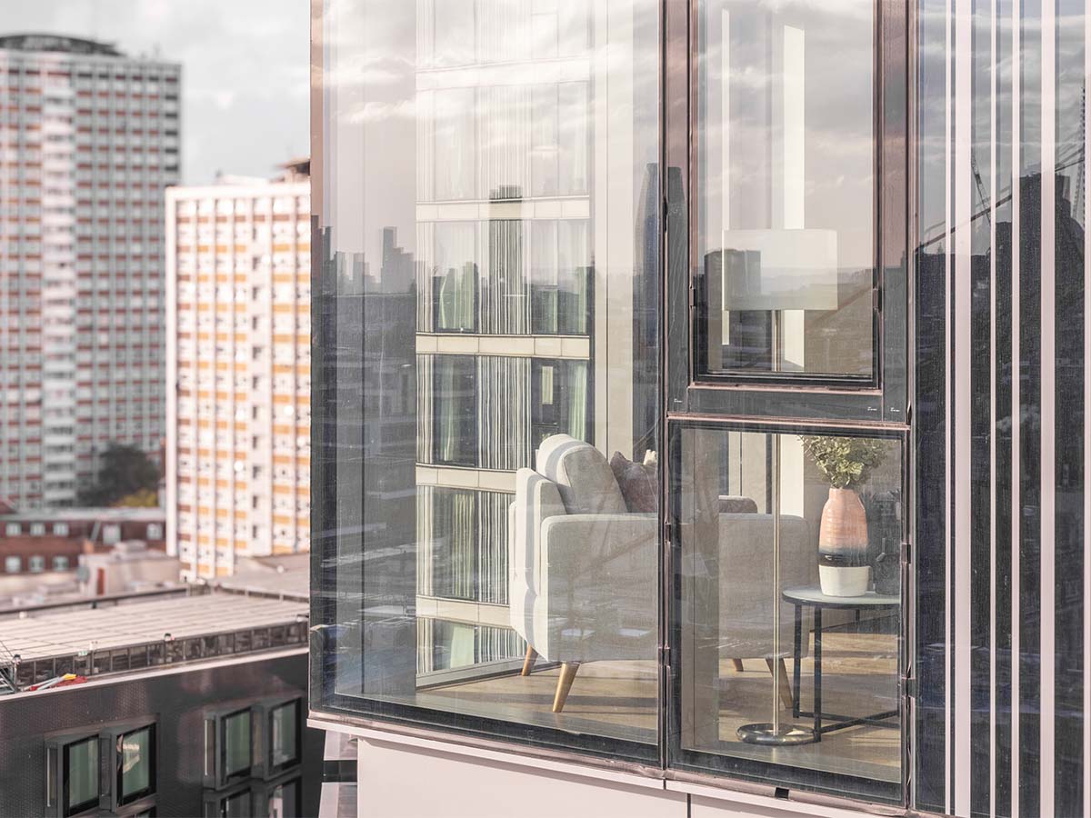 Sofa and side table reflected in building glass