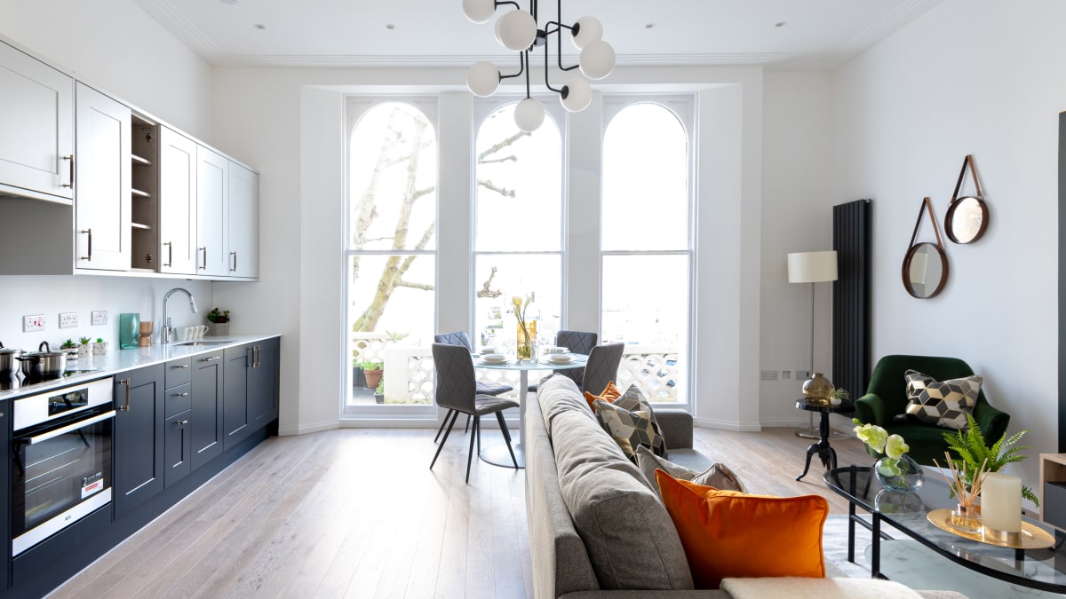 Bright living space with kitchen, dining area, and sofa