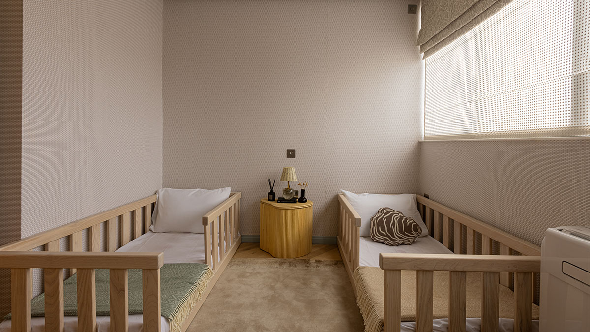 Nursery room with two beds and side table