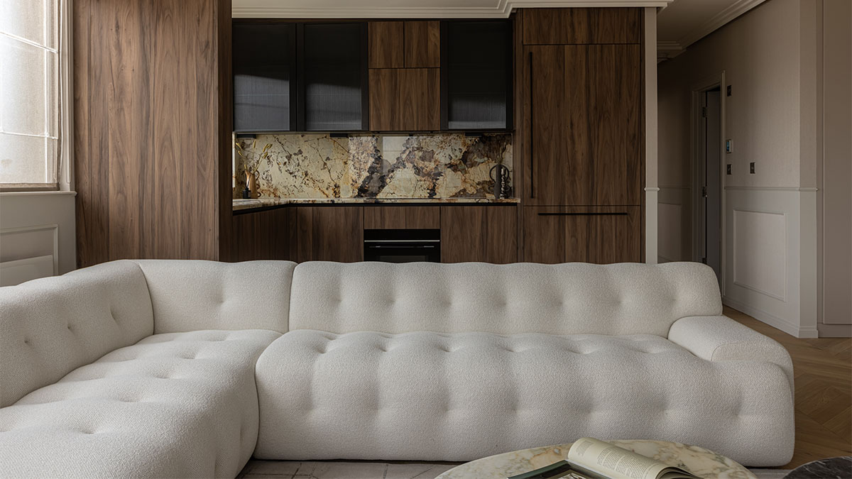 White sectional sofa and modern kitchen view