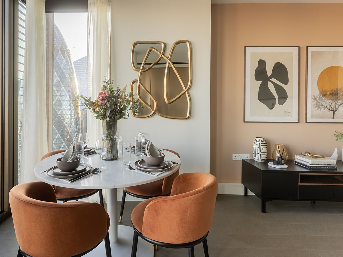 Stylish Dining Nook with City View and Gold Mirror