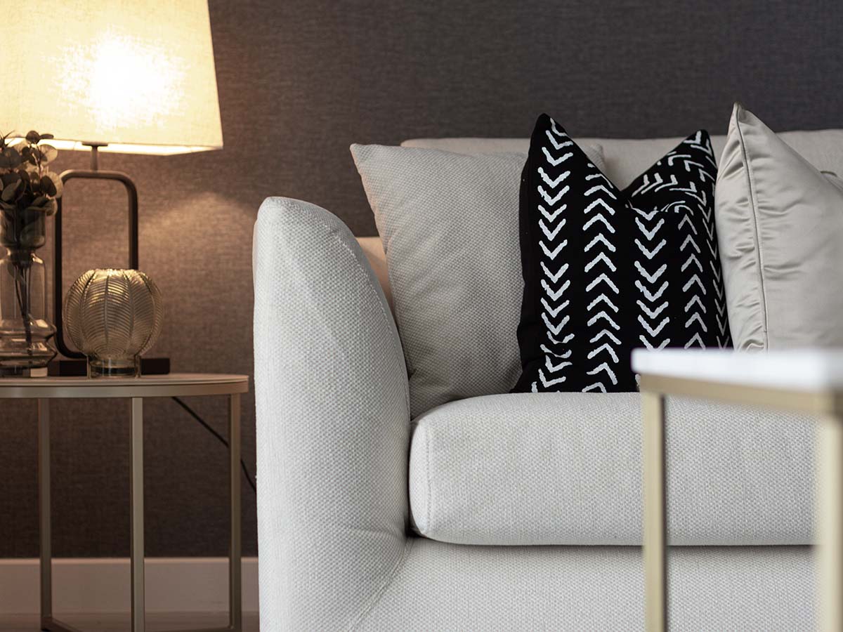 Soft white couch with decorative pillows