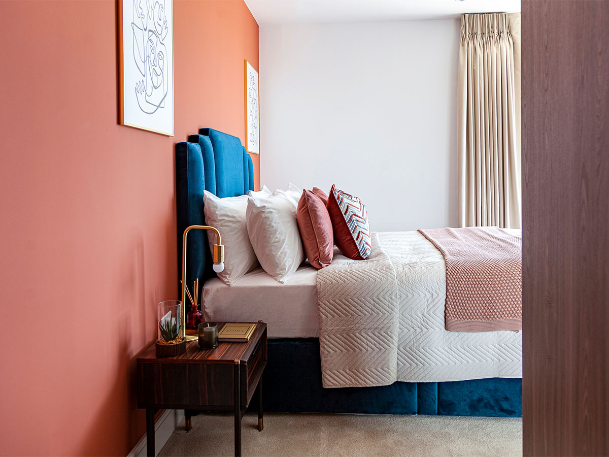 Interior bedroom with soft bedding and side table