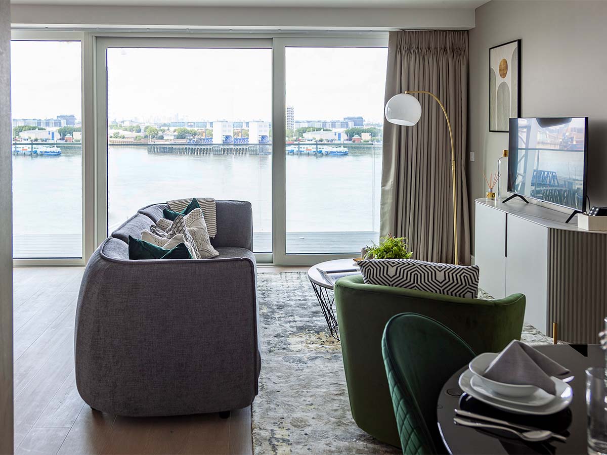 Living room with TV and dining table, river view