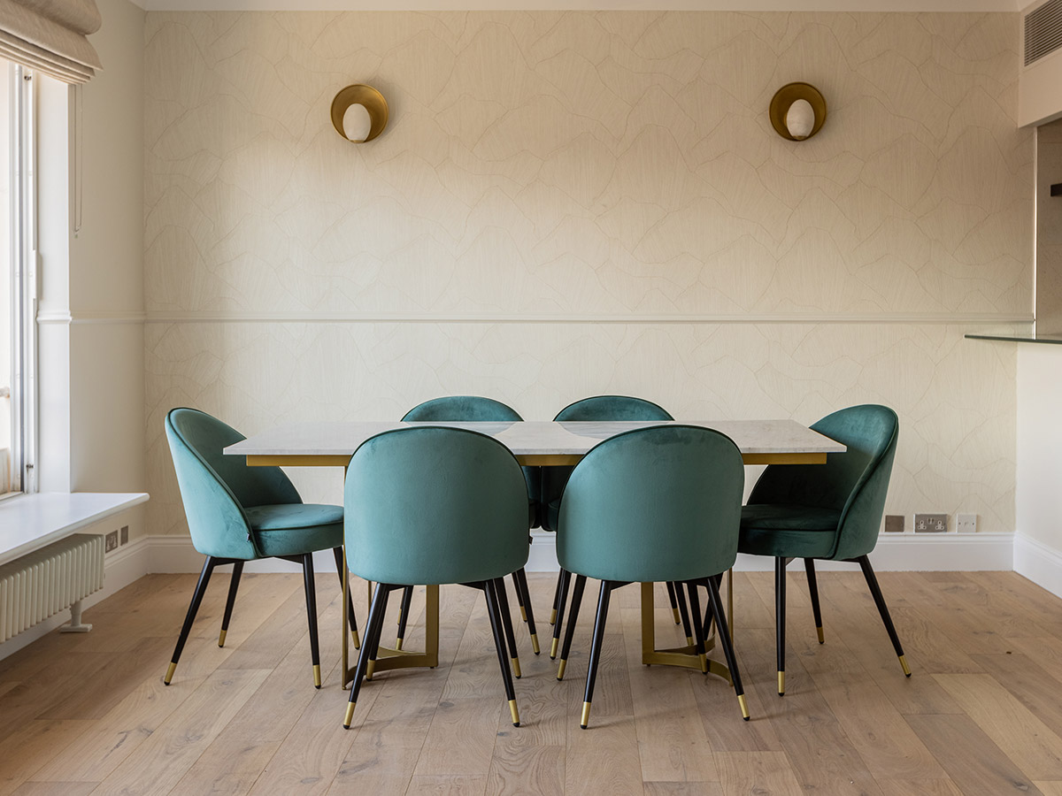 Stylish dining area with gold wall sconces
