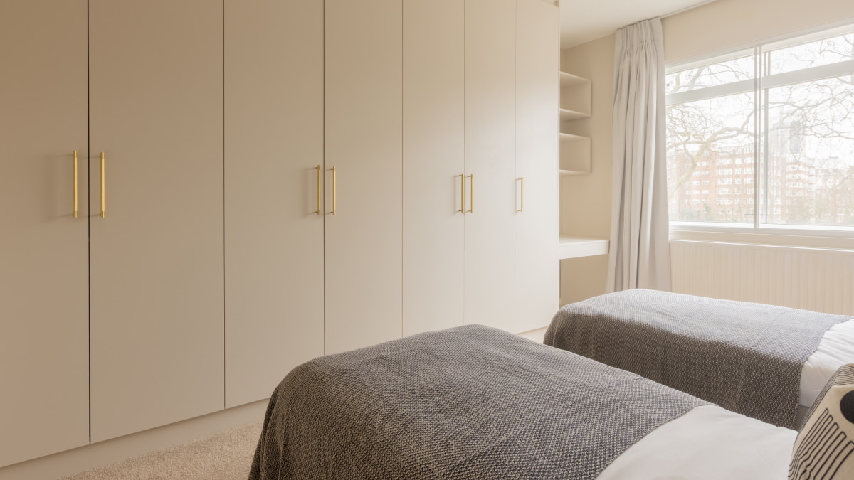 Modern twin bedroom with fitted wardrobes and built-in nook