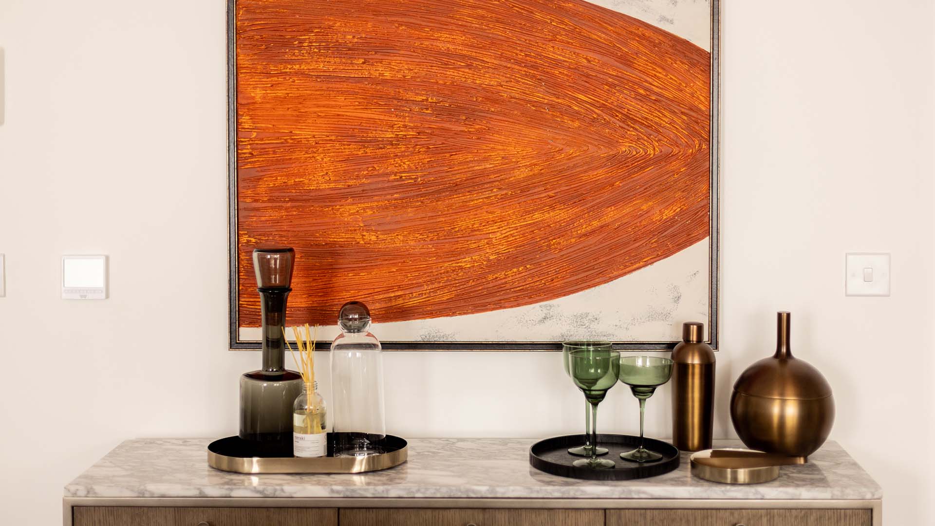 Stylish decor with orange abstract art at Fulton & Fifth