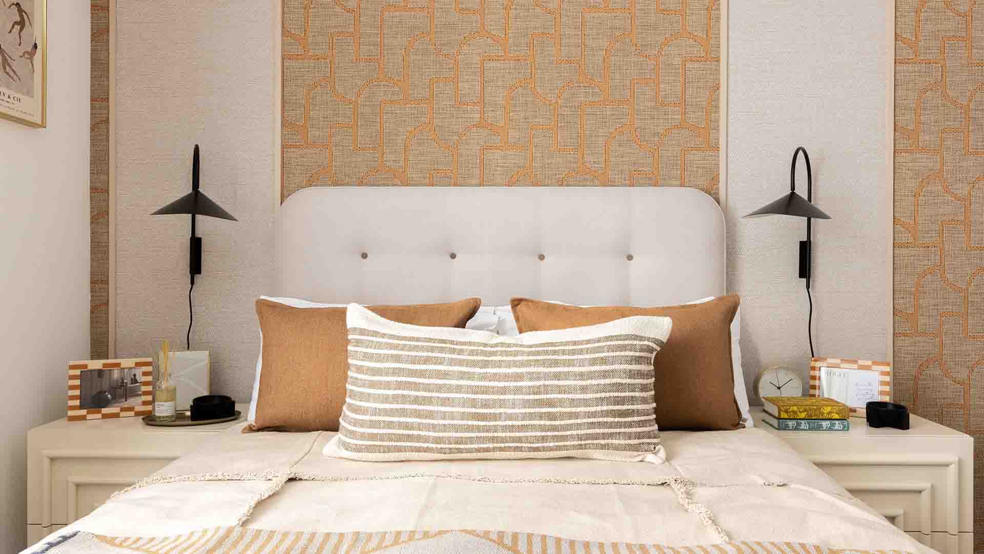 Stylish bed with sconce lighting at Fulton & Fifth