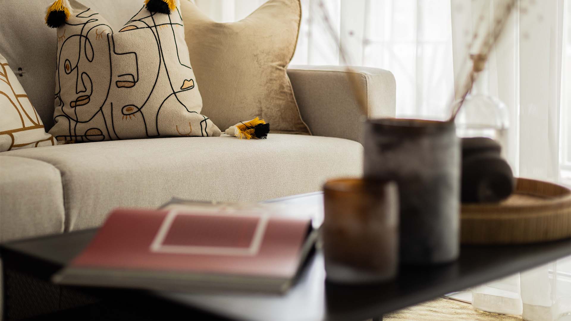 Modern sofa with book and vase decor