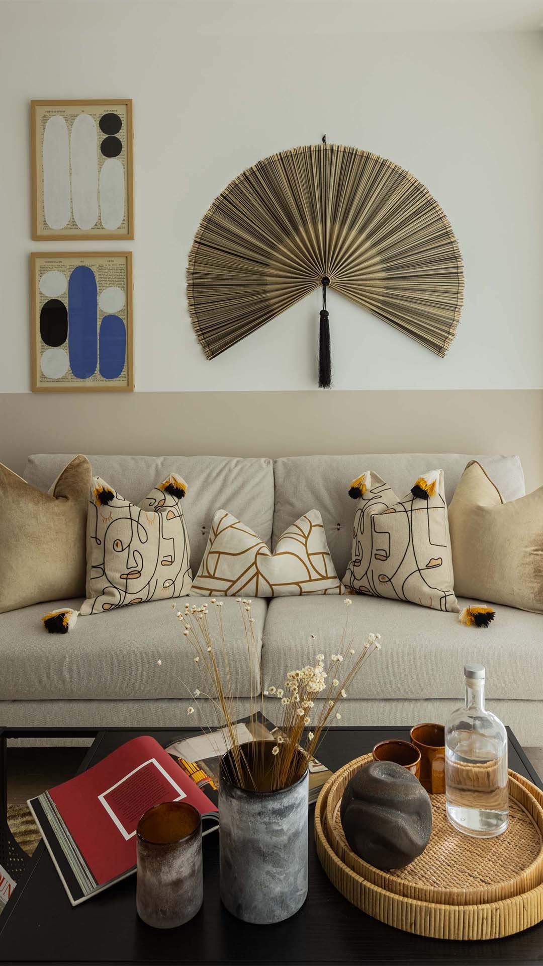 Modern sofa with patterned cushions and art