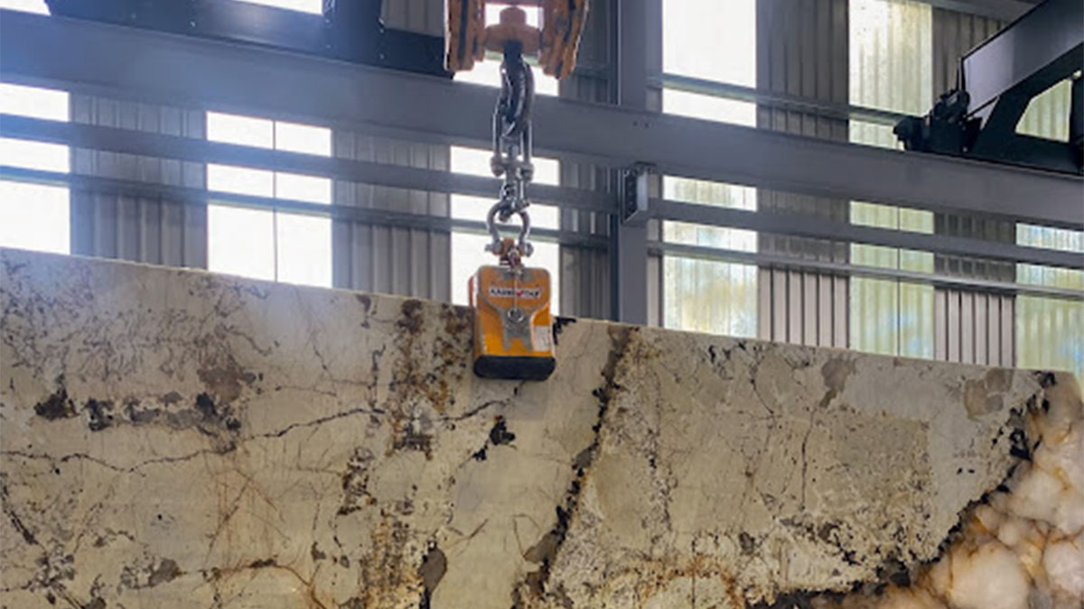 Large stone slab being lifted by crane