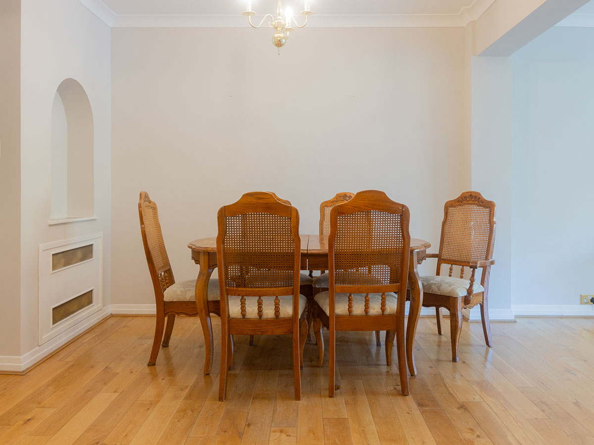 Before: dining room with wooden table and chairs