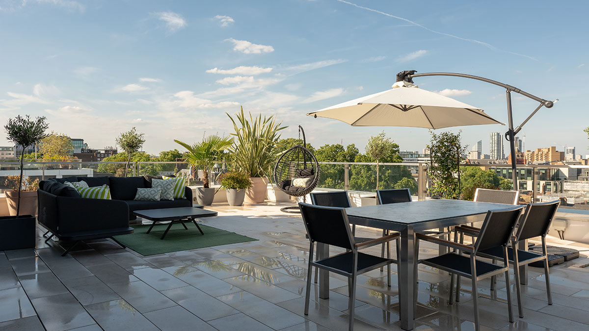 Terrace at 18 Portugal St with dining set, lounge sofa, and skyline view