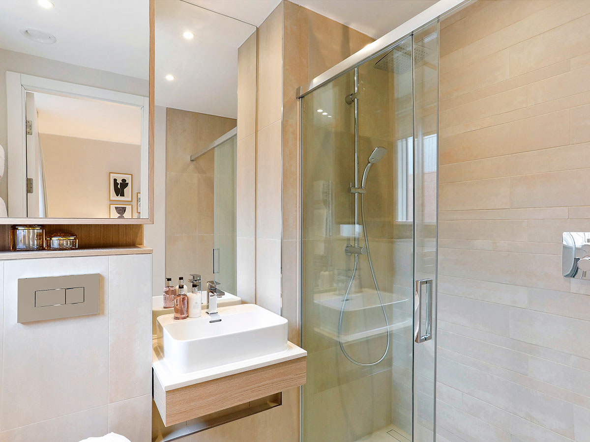 bathroom-with-glass-shower-enclosure-floating-vanity-and-neutral-tile