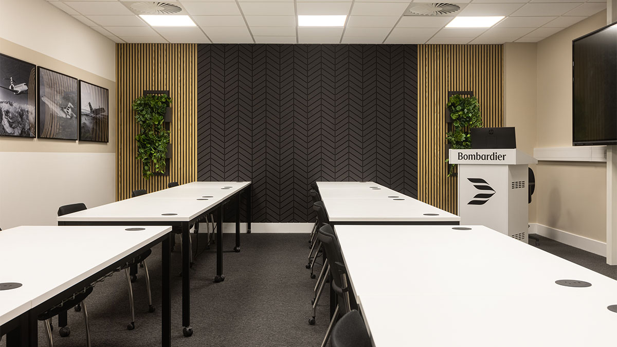 Interior meeting space, training setup with tables of Bombaride