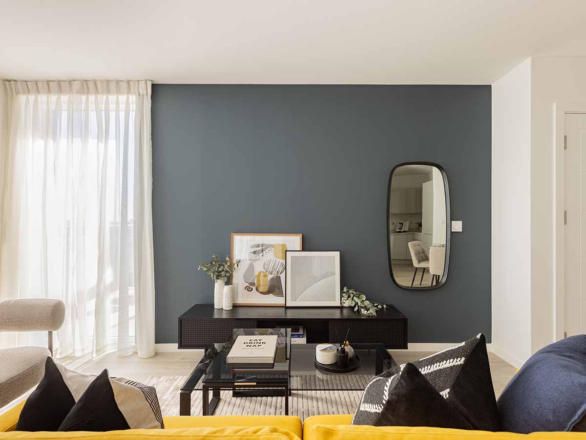 Modern living room with dark accent wall and art