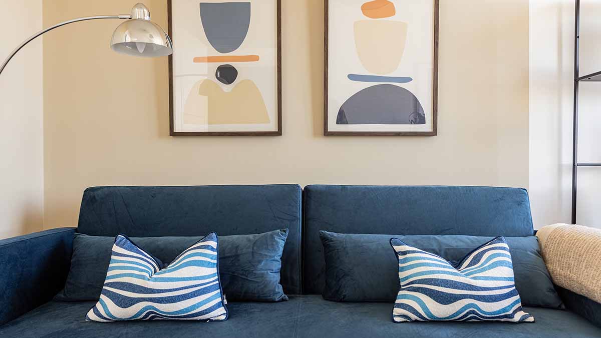 Close-up of a stylish blue sofa in a London flat, illustrating the quality and contemporary design of an InStyle Direct furnishing package.