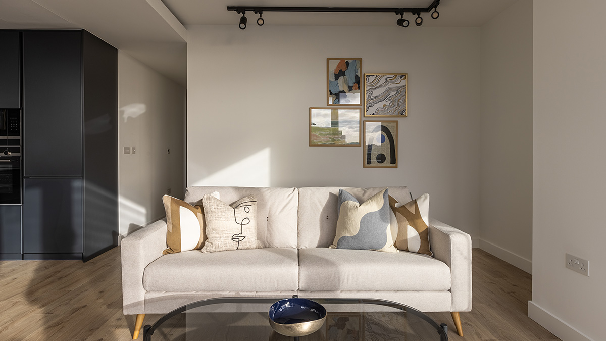 Modern London living room featuring a stylish art gallery wall and comfortable sofa, a testament to InStyle Direct transformations