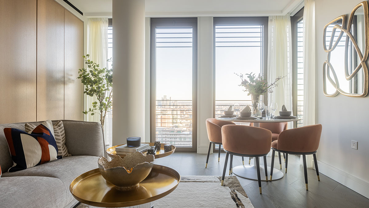 Stylish London apartment living and dining area with city view and velvet chairs 