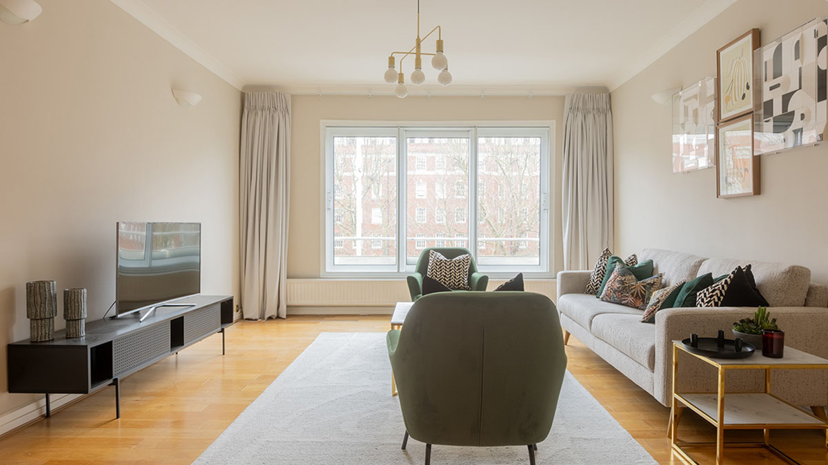 Bright SW7 living room with large window, modern seating, and layered lighting