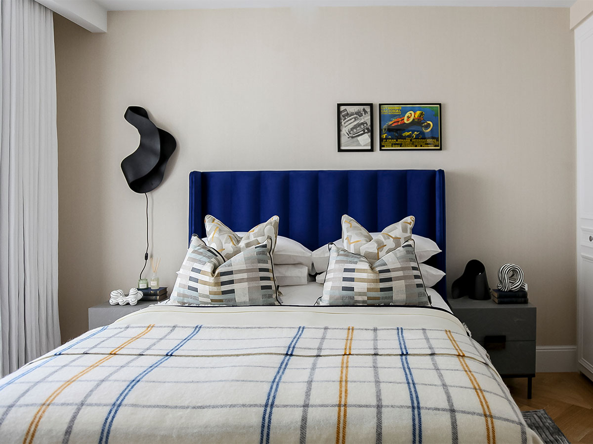 Stylish bedroom, blue headboard and art detail