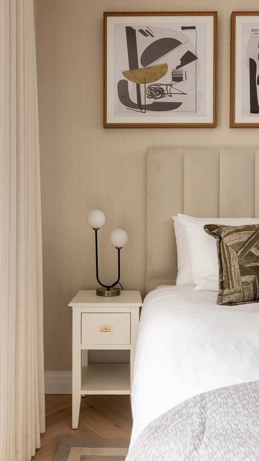 Modern nightstand with a unique lamp and abstract art in a Kings Tower Chelsea London flat bedroom