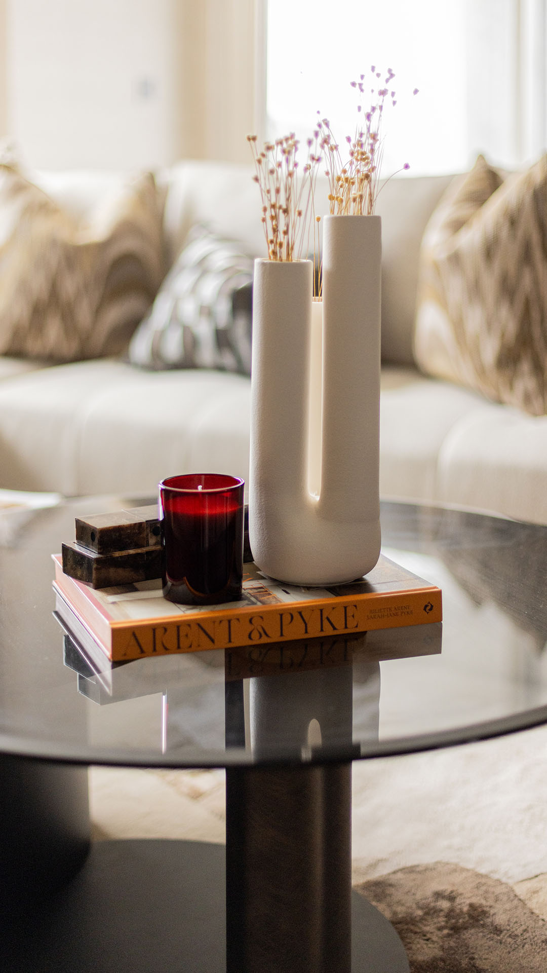 Close-up of coffee table decor in a Kings Tower Chelsea London flat, showing stylish accents and books