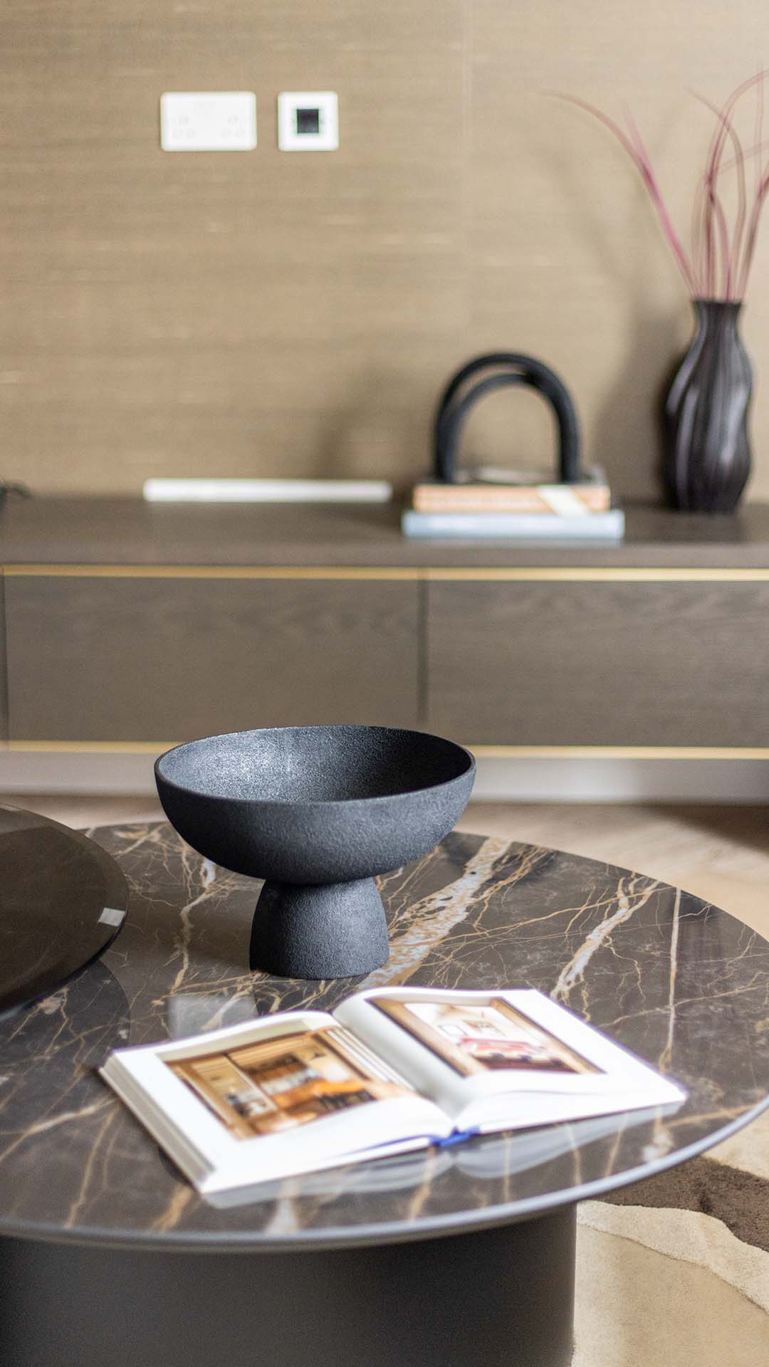 Contemporary coffee table styling with a matte black bowl and magazine in a Kings Tower Chelsea London flat