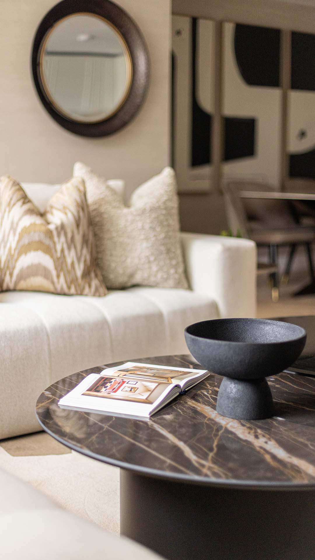 Close-up of a coffee table with a decorative bowl and open book in a Kings Tower Chelsea London flat's living room