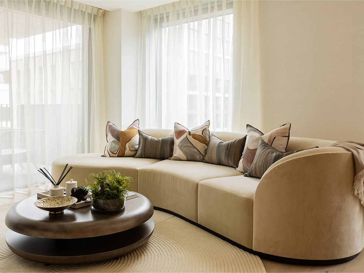 Chic curved sofa and coffee table creating a welcoming living space in a London investment flat