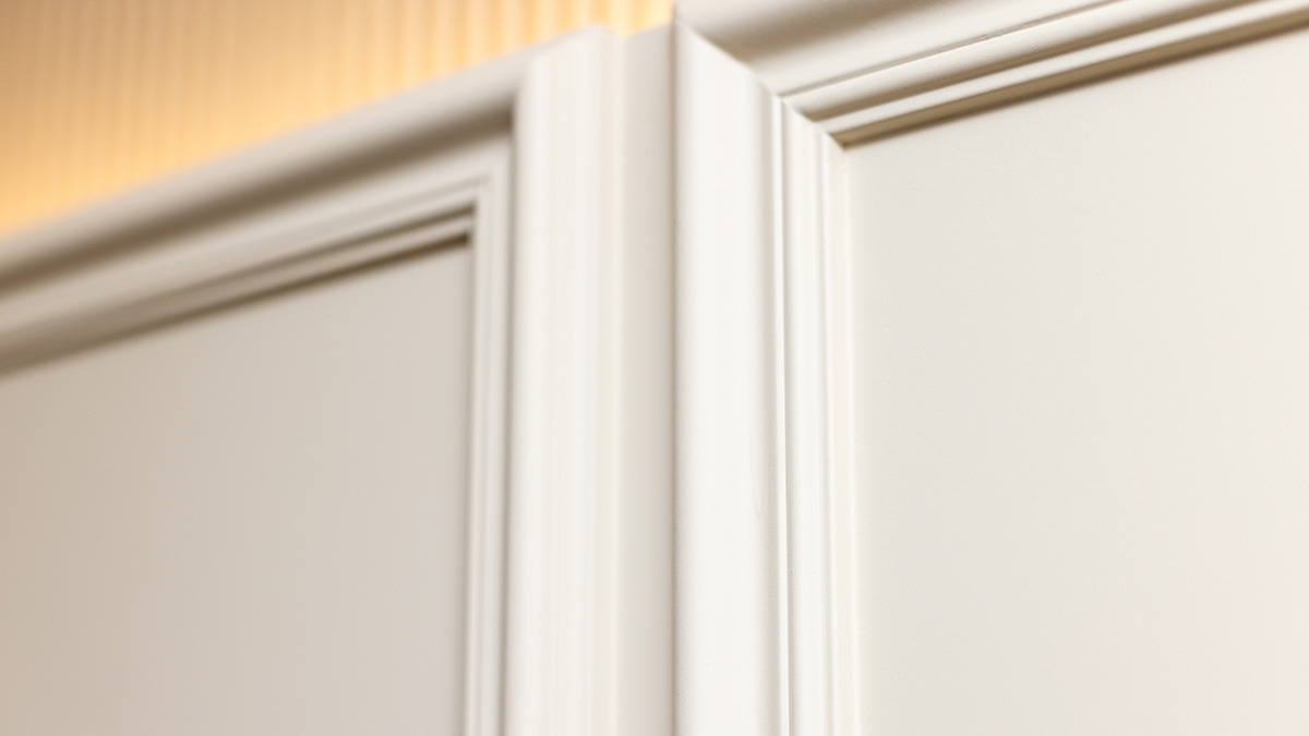 Close-up view of detailed white interior moulding and trim, highlighting the craftsmanship and classic design elements in a London flat renovation