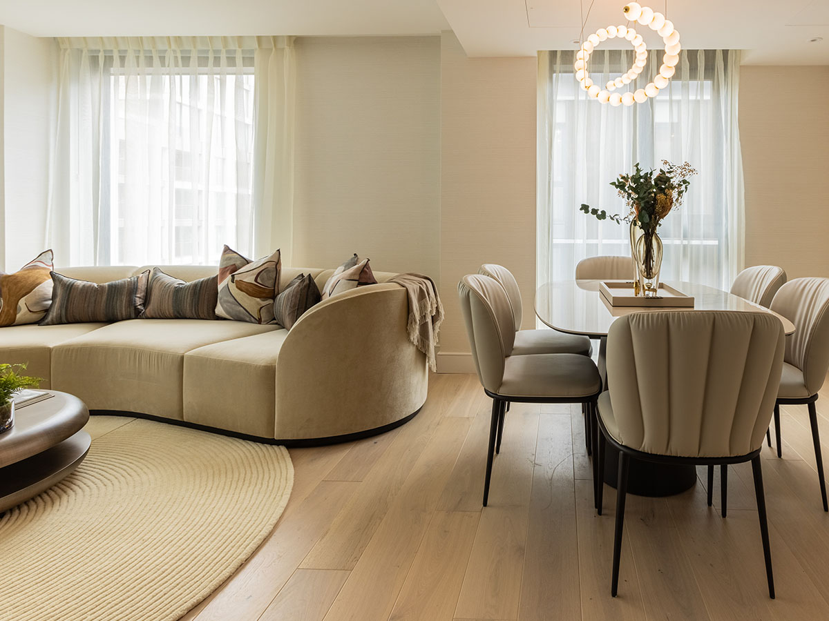 Wide shot of a professionally furnished living and dining area in a London flat, ideal for overseas investors