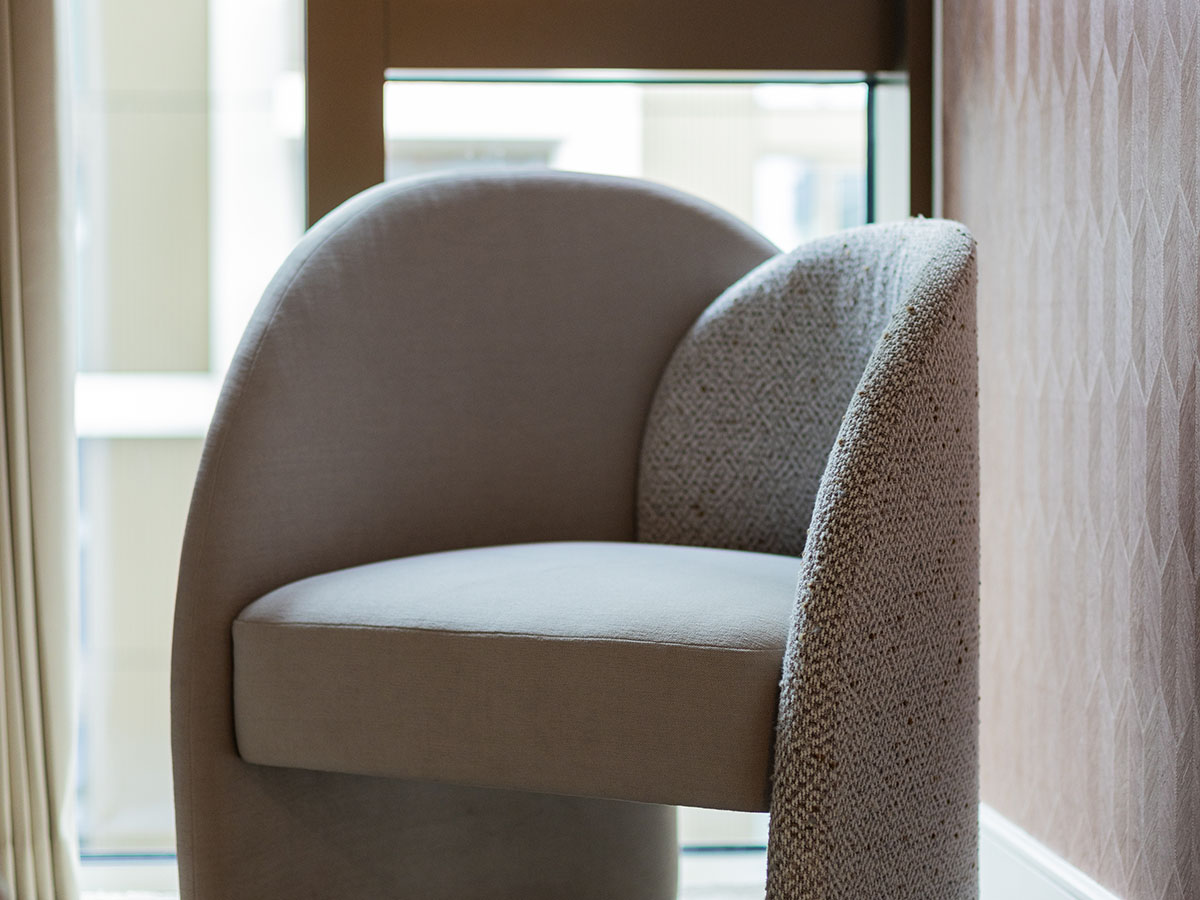 Luxurious curved armchair enhancing London flat's rental appeal, perfect for modern interiors