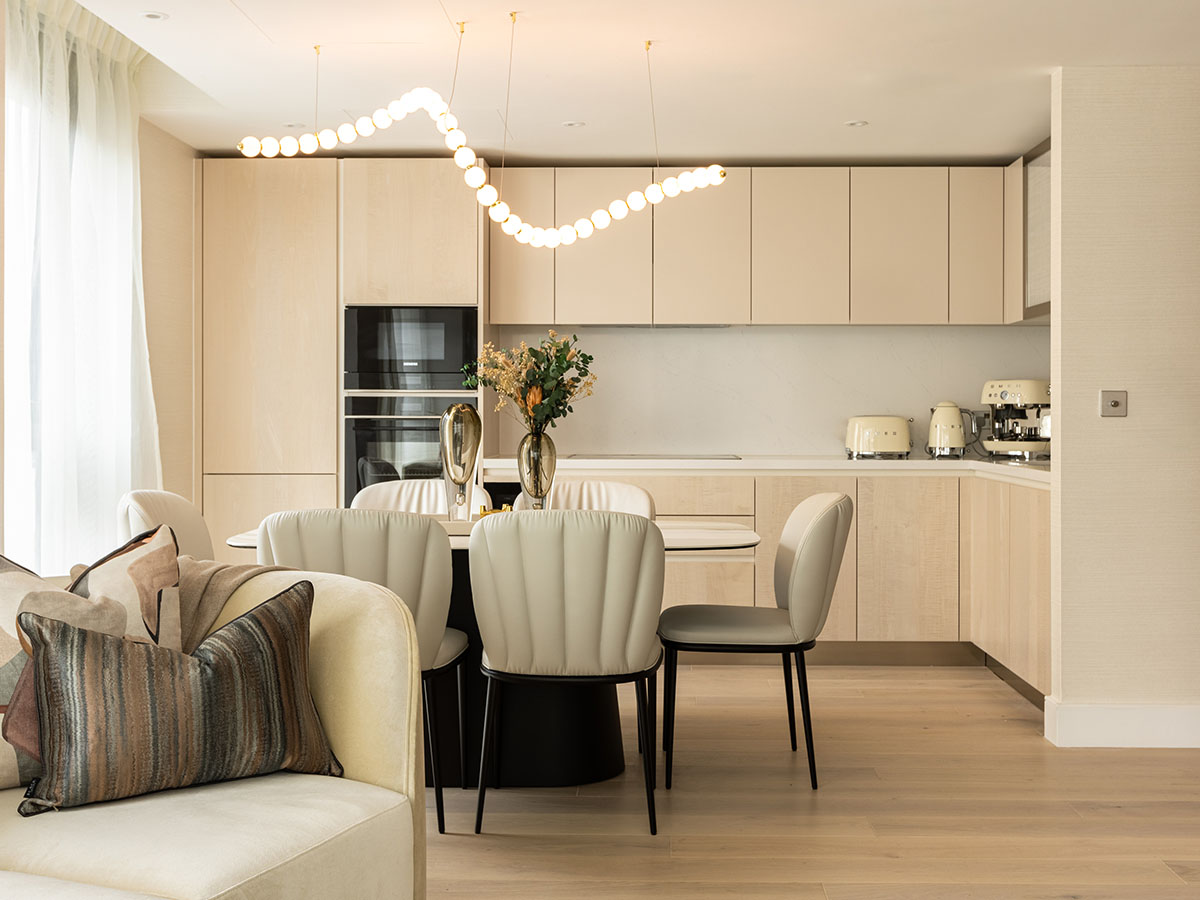 Bright open-plan kitchen and dining space in a London flat, showcasing modern furnishing packages