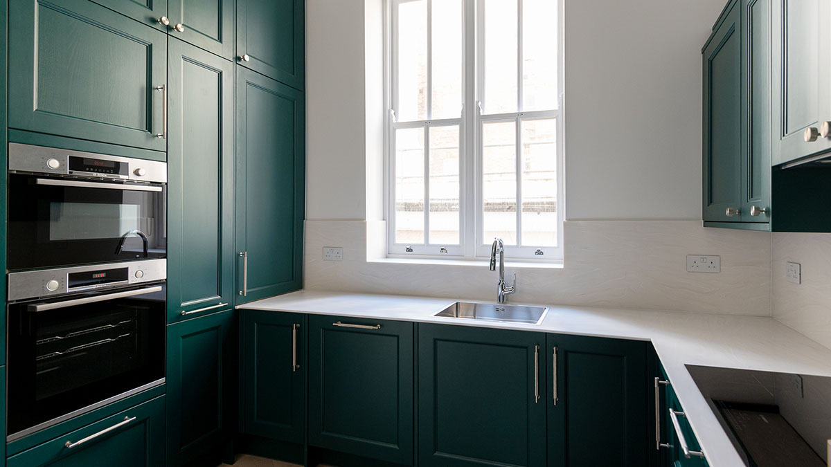 Elegant green kitchen in London rental flat, demonstrating a significant furnishing upgrade by InStyle Direct