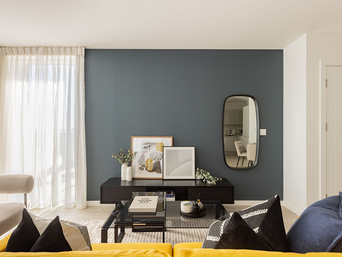  Stylish living room interior with a media console and decorative mirror, reflecting expert interior design for a London rental property