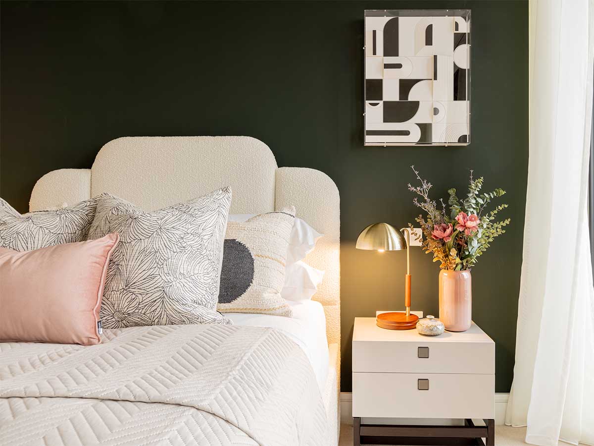 Stylish bedroom with statement headboard and green accent wall by Instyle Direct