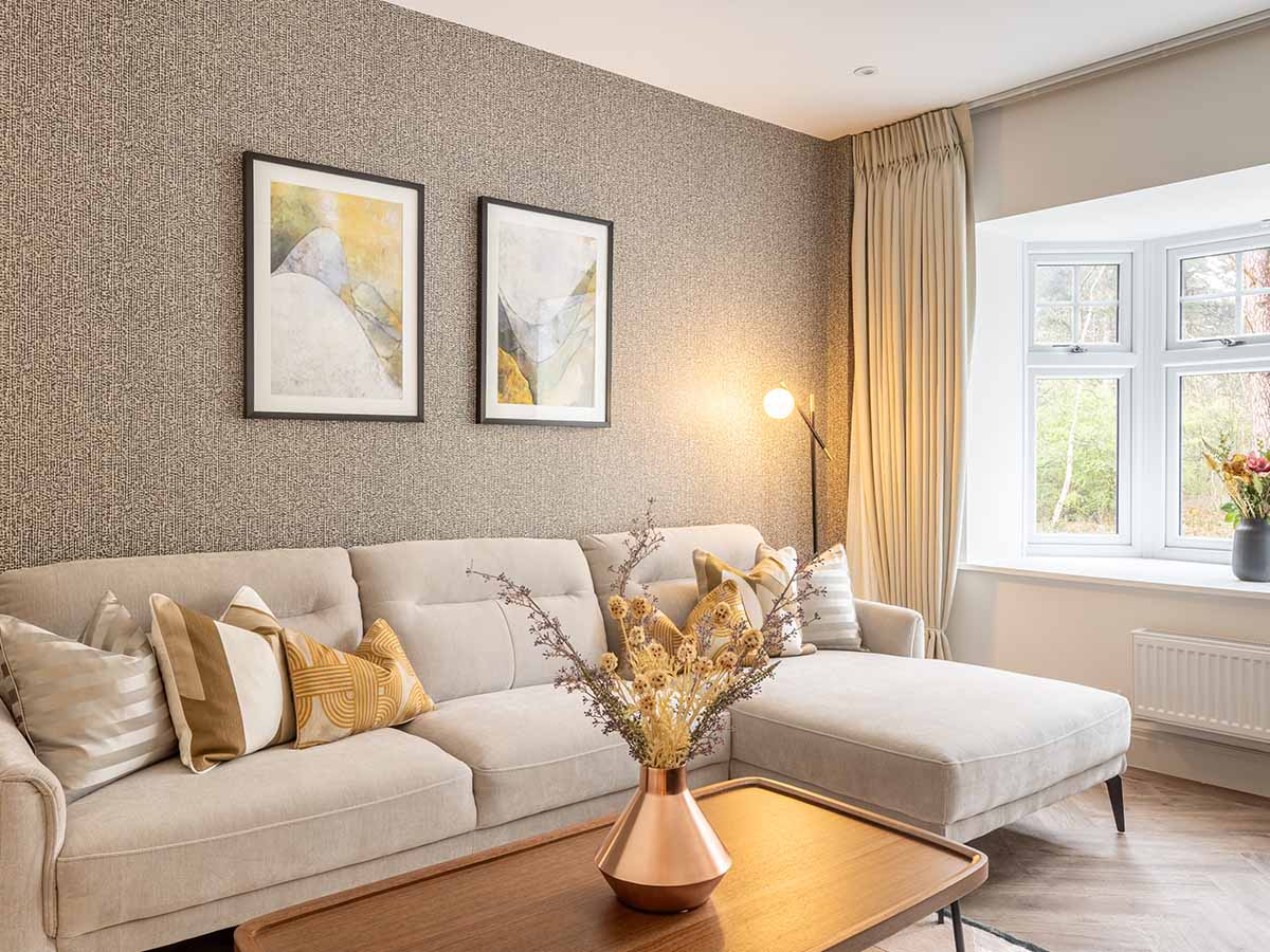 Living room with a textured wallpaper and neutral sectional sofa