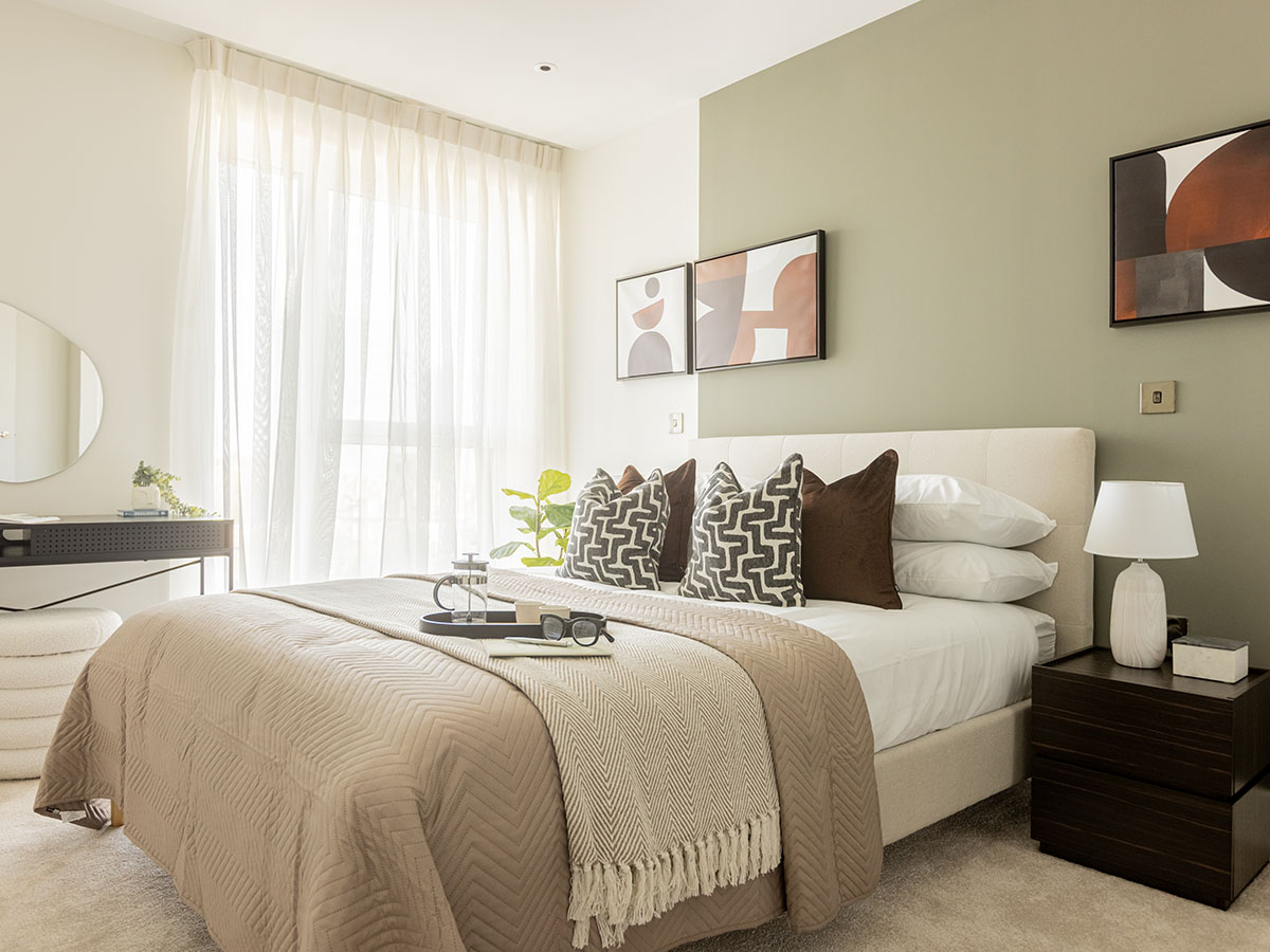 Bedroom with a sage green feature wall