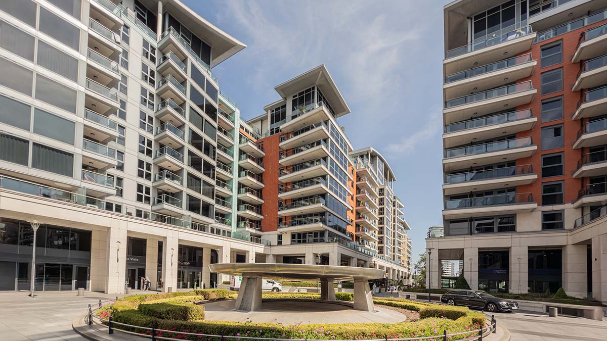 The grand entrance plaza of Thames Point on The Boulevard at Imperial Wharf, London, showcasing modern luxury apartment buildings