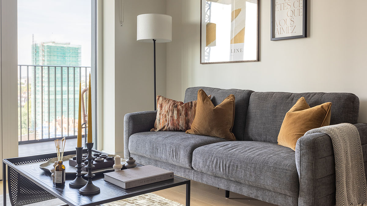 Professionally furnished London apartment living room designed for overseas landlords, featuring modern decor and a sofa