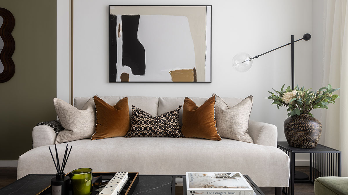 Close-up of a modern sofa with accent pillows in a professionally furnished London flat, perfect for rental market